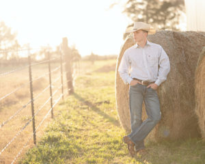 Senior Portrait with hay and cowboy hat