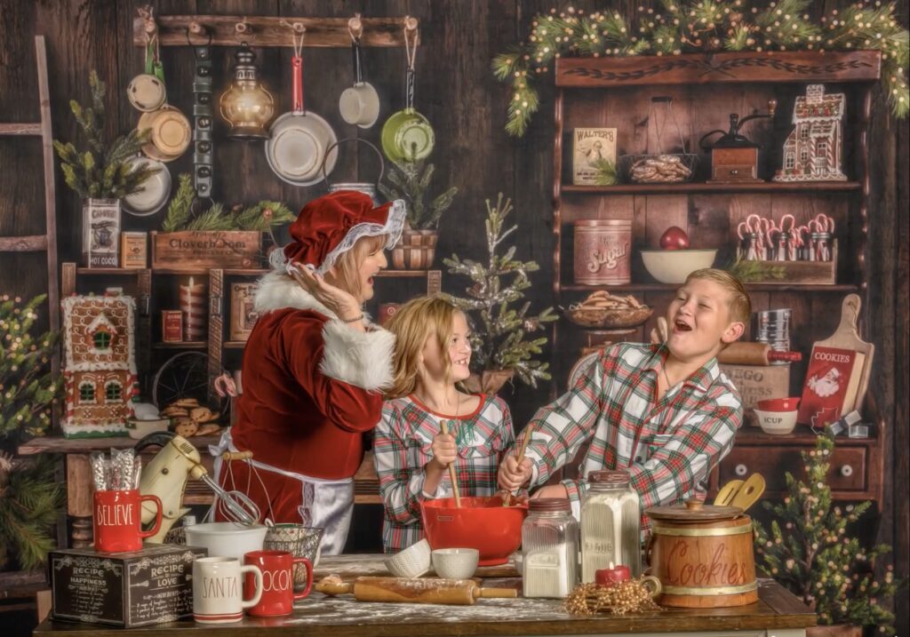 Mrs. Claus baking cookies with children having a flour fight