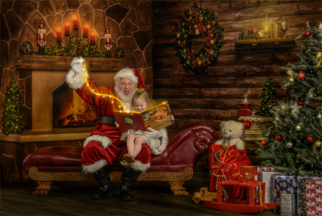  Little girl sitting on Santa’s lap as he reads “The Night Before Christmas” with magic