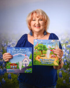 Elizabeth Howard smiling in a professional headshot, holding two of her Christian children’s books: Tickle Tickle Goes to Church and Tickle Tickle My Feather Friend.